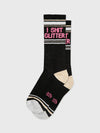Black and silver socks with pink text reading "I SHIT GLITTER"