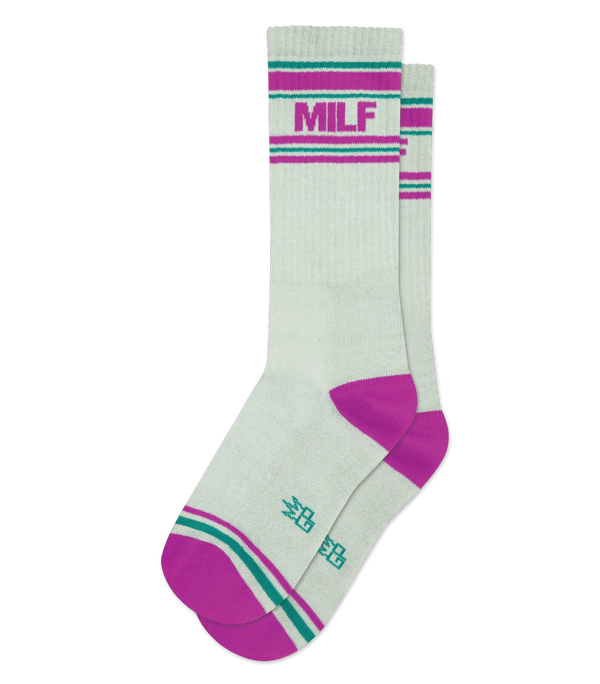 Image shows a pair of gray crew socks in flatlay. They have magenta heels, teal and magenta striped patterns at the toe and ankle, and magenta text that reads "MILF"