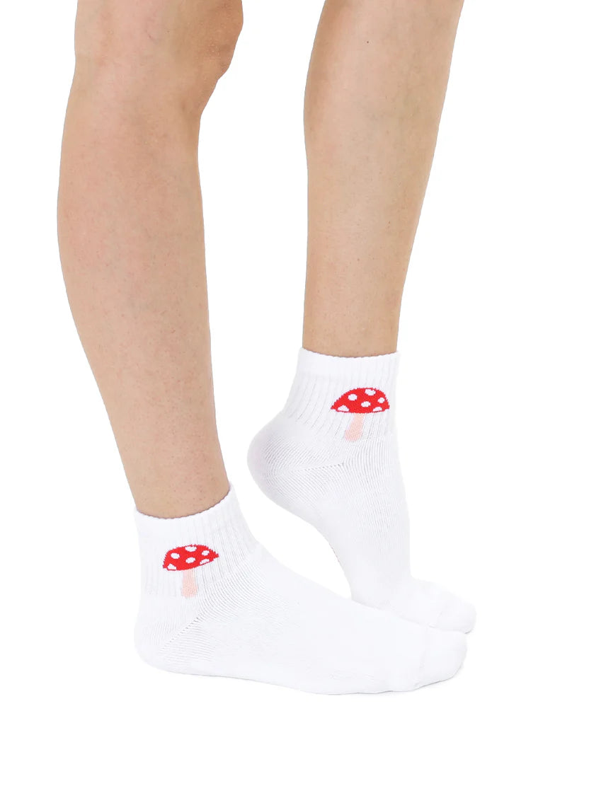 Model wears white ankle socks with red mushroom design