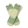 Two fuzzy green crew socks with blushing frog faces at the top are shown in flatlay on a white background.