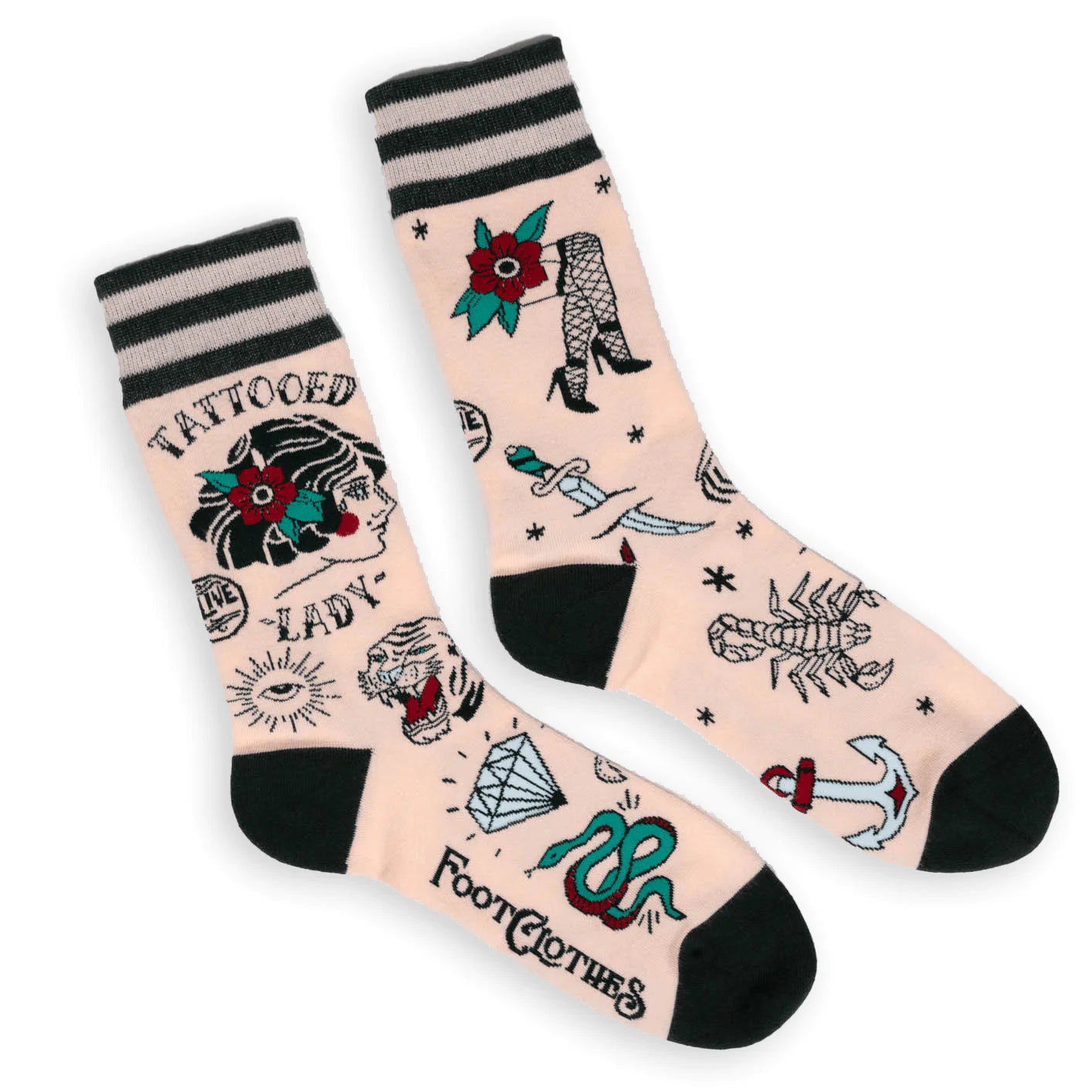 Shown in a flatlay, a pair of unisex crew socks in light pink with a gray heel and toe. These socks feature an all over motif of classic tattoo art with the words 