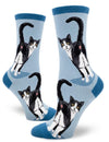 a light blue pair of socks featuring two tuxedo cats showing off their butt holes with a darker blue toe, heel and cuff