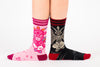 Two model's legs line up against each other to show off the Evil AF and Cute  versions of the Baphomet Crew Socks by Foot Clothes.