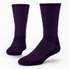 a pair of ribbed dark purple merino wool hiking socks on leg forms