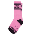 Shown laid flat, a pair of pink cotton Gumball Poodle brand unisex crew socks with black striped toe and cuff. These socks feature the words, "HOT HOMO" on the leg in black.