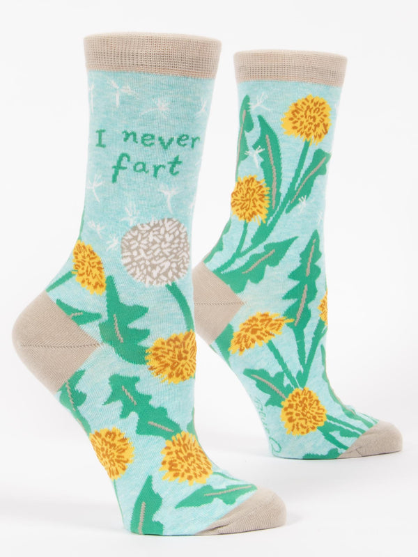 Shown on leg forms, a pair of light blue Blue Q socks with a grey heel, toe, and cuff. The feature a dandelion and puffball design on the foot and the phrase, "I never fart" on the leg.