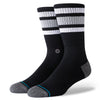 a pair of black socks modeled on a foot form with a grey toe and heel, and three monochromatic stripes near the cuff