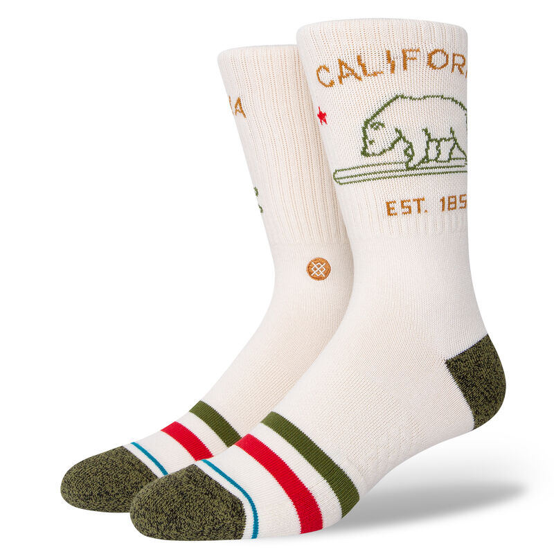 a pair of ivory socks on leg forms with a green toe and heel and a minimal design of the california bear in green with text above and below that reads california est. 1850