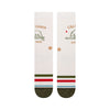 a flatlay of a pair of ivory socks with a green toe and red and green stripes on the ball of the foot with a minimal line drawing of the california bear in green with text above and below that reads california est. 1850