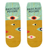 Shown in a flatlay, a pair of Blue Q cotton women’s quarter length socks with mustard yellow and mint green background, mysterious eyes pattern, and “Basically Psychic” text