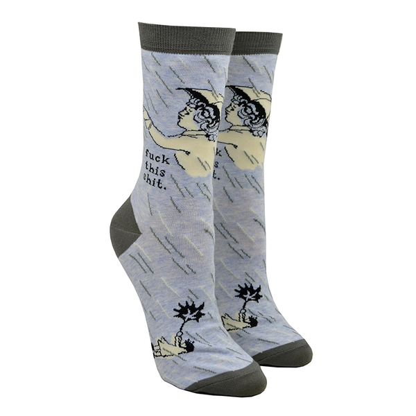 Shown on leg forms, a pair of women's Blue Q brand combed cotton crew socks in blue with a grey heel, toe, and cuff and a cartoon women with an umbrella. The leg features the phrase, "Fuck this shit." and the foot has a smaller cartoon of a woman with a blown backwards umbrella.