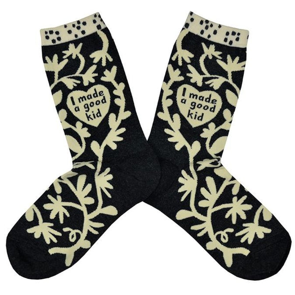 Shown in a flatlay, a pair of women's Blue Q socks in grey with a cream colored cuff. The sock has an all over motif of abstract floral vines in cream with a heart in the center of the leg of the sock that reads, "I made a good kid".