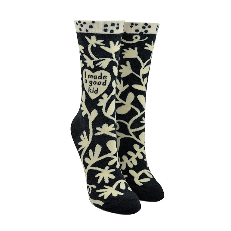 Shown on leg forms, a pair of women's Blue Q socks in grey with a cream colored cuff. The sock has an all over motif of abstract floral vines in cream with a heart in the center of the leg of the sock that reads, 