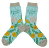 Shown in a flatlay, a pair of light blue Blue Q socks with a grey heel, toe, and cuff. They feature a dandelion and puffball design on the foot with the words, "I never fart" on the leg of the sock. 