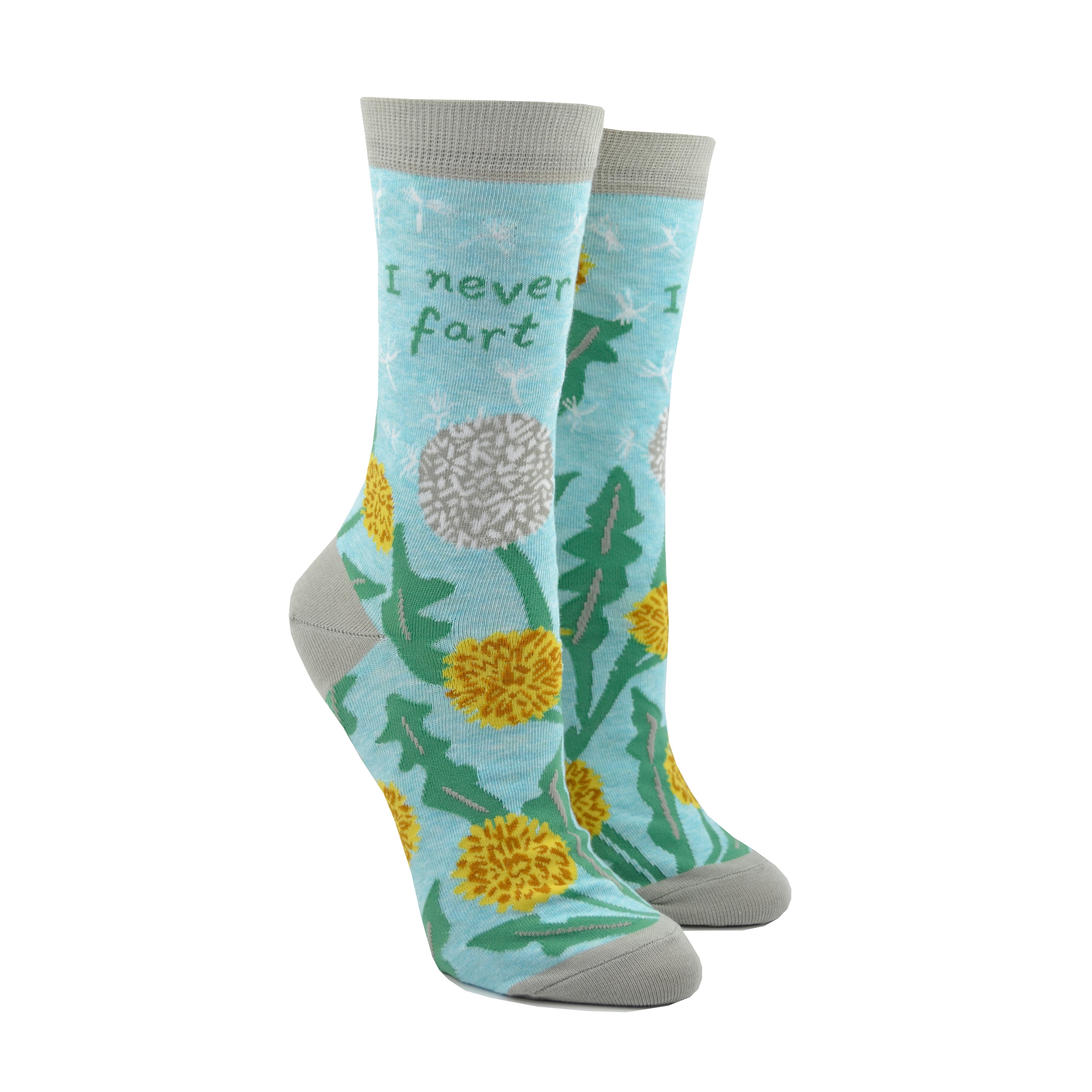 Shown on leg forms, a pair of light blue Blue Q socks with a grey heel, toe, and cuff. The feature a dandelion and puffball design on the foot and the phrase, 