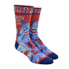 Shown on a leg form, a pair of Blue Q cotton men’s crew socks with warm brown and denim blue cats, as well as the words “Crazy Cat Dude”