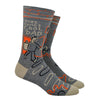 Shown on a leg form, a pair of Blue Q gray cotton men’s crew socks with a dad giving a thumbs up and the text “Here Comes Cool Dad”