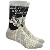 Shown on leg forms, a pair of Blue Q brand men's cotton crew socks in grey and black with an abstract crisscross design along the foot and a sad sock sitting on stairs on the leg. The text on the sock reads, "Worst Gift Ever" along the top.