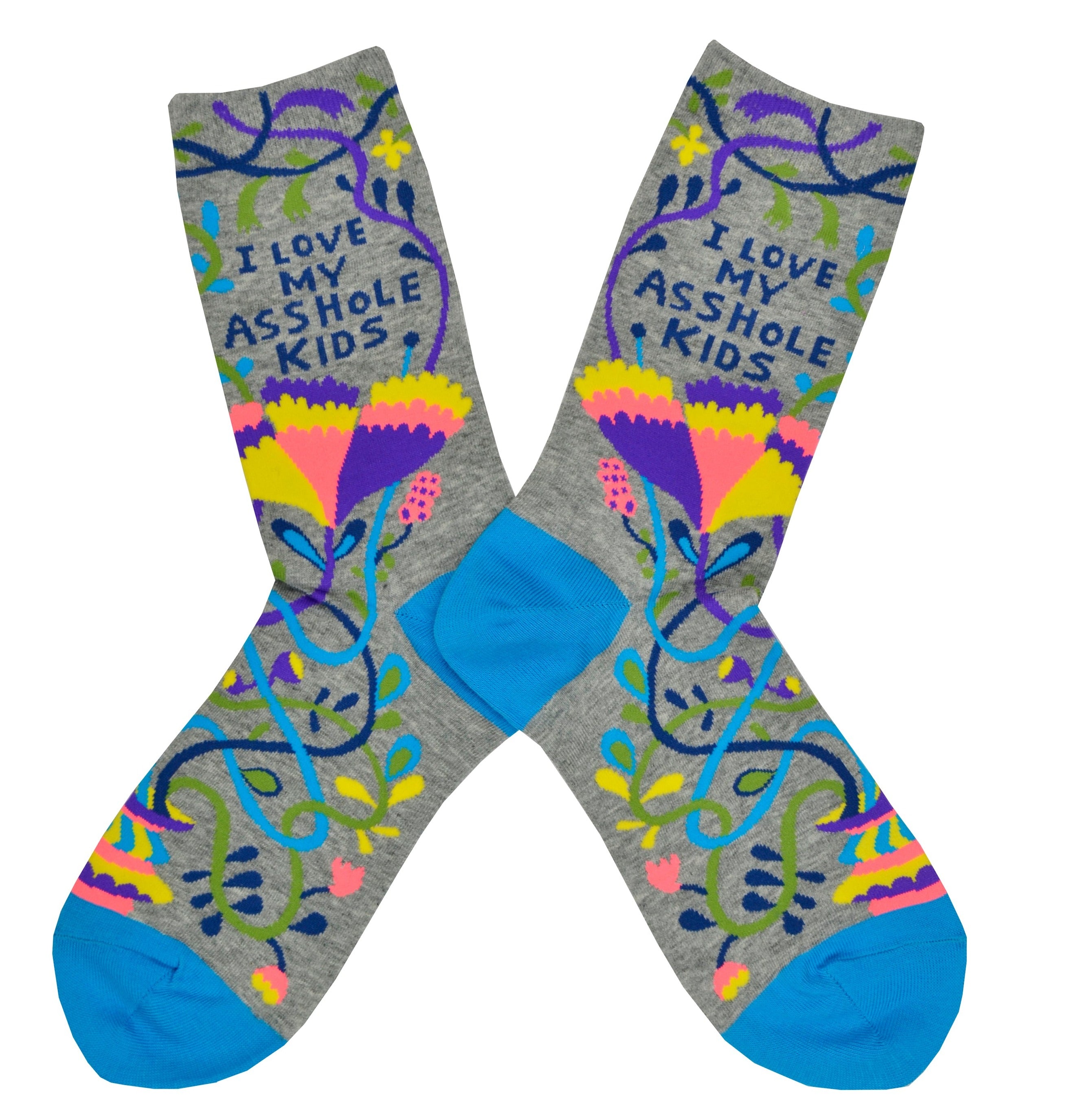 Shown in a flatlay, a pair of women's Blue Q brand combed cotton crew sock in grey with a teal heel and toe. The socks feature an abstract floral design in yellow, purple, orange, and teal with the words, 