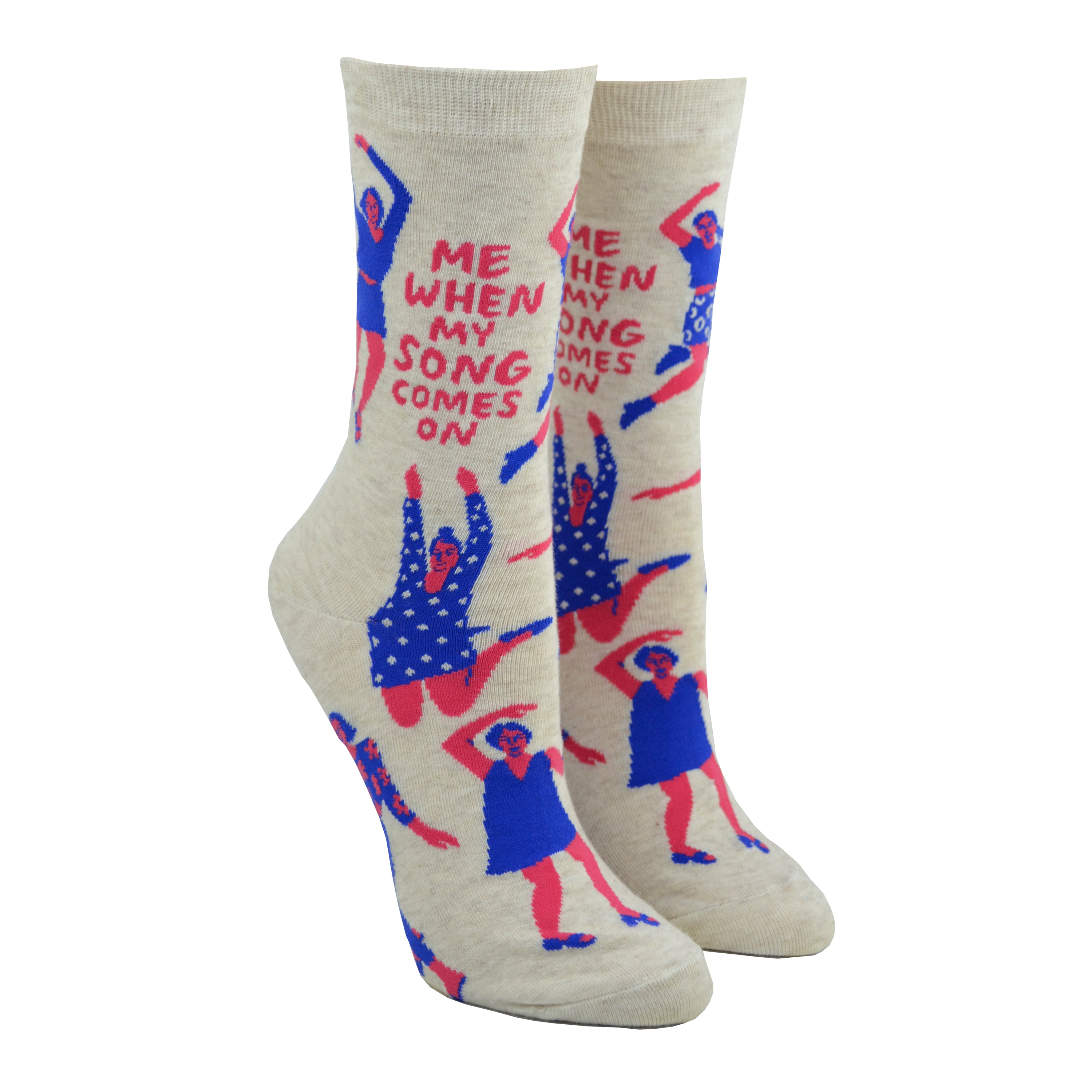 Shown on a leg form, these cream cotton women's novelty crew socks by the brand Blue Q feature pink women wearing purple clothes dancing in different styles and the quote 