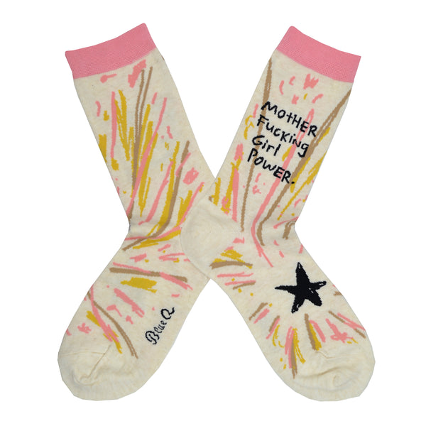 A pair of cream colored socks lay flat with the words "Motherfucking Girl Power" written on the leg and a black star on the foot of this Blue Q cotton crew sock.