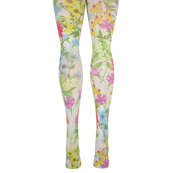 Shown on a leg form from the back, a pair of white lycra tights with delicate floral plants twisting around them, including daisies, roses and violets with green stems