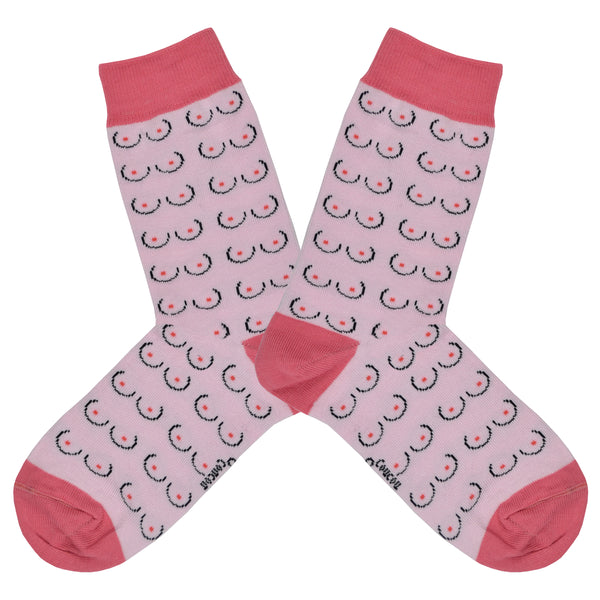 Shown in a flatlay, a pair of Coucou Suzette cotton women’s crew socks with minimalistic boob pattern in light pink skin color