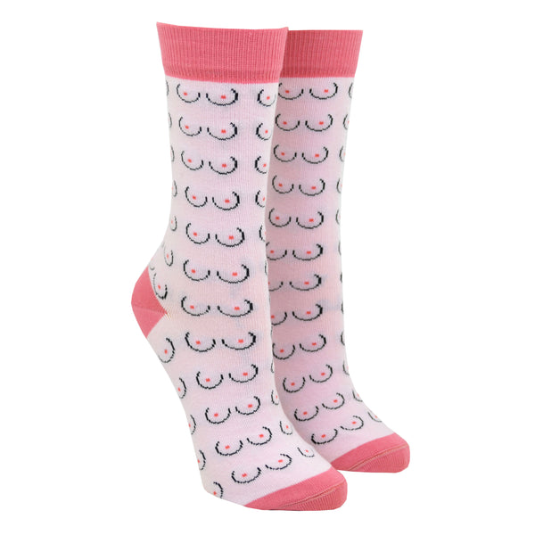 Shown on a leg form, a pair of Coucou Suzette cotton women’s crew socks with minimalistic boob pattern in light pink skin color