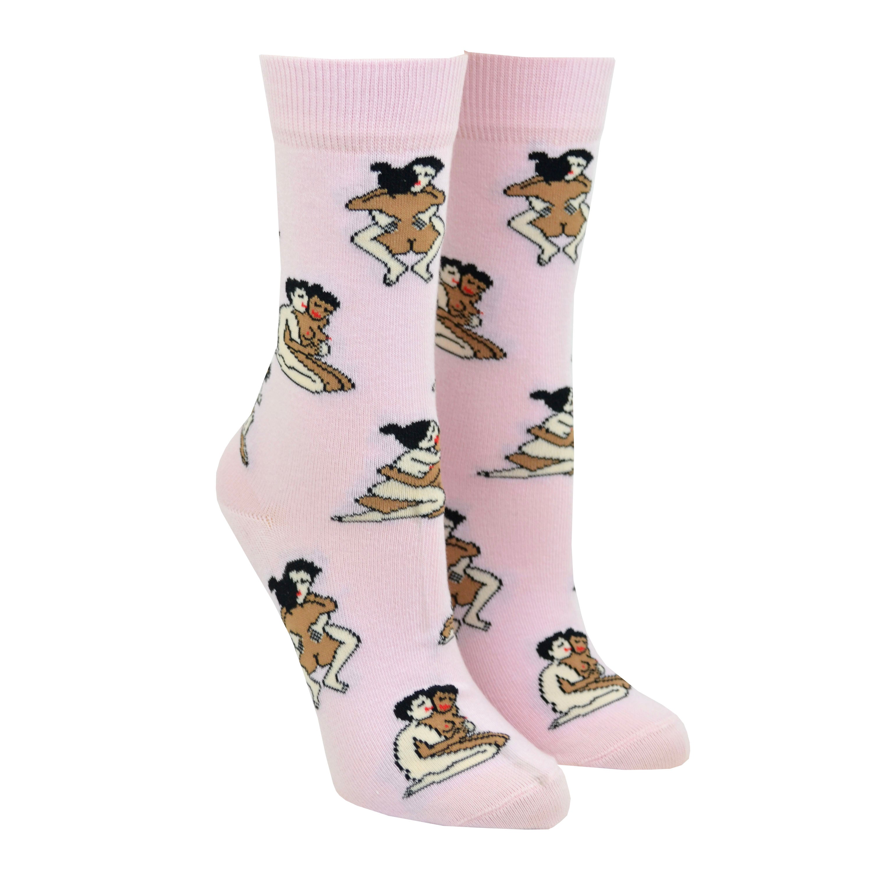 Shown on leg forms, a pair of light pink socks that show a straight interracial couple in various sex positions from the Kama Sutra all over the sock.