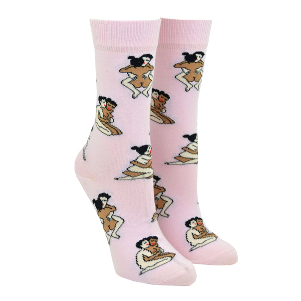 Shown on leg forms, a pair of light pink socks that show a straight interracial couple in various sex positions from the Kama Sutra all over the sock.