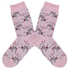 These pink cotton women's crew socks by the brand Coucou Suzette feature bare breasts and a hand pinching one of the nipples.
