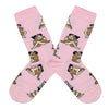 Shown in a flatlay, a pair of light pink socks that show an interracial straight couple in various sexual positions from the Kama Sutra all over the sock. 