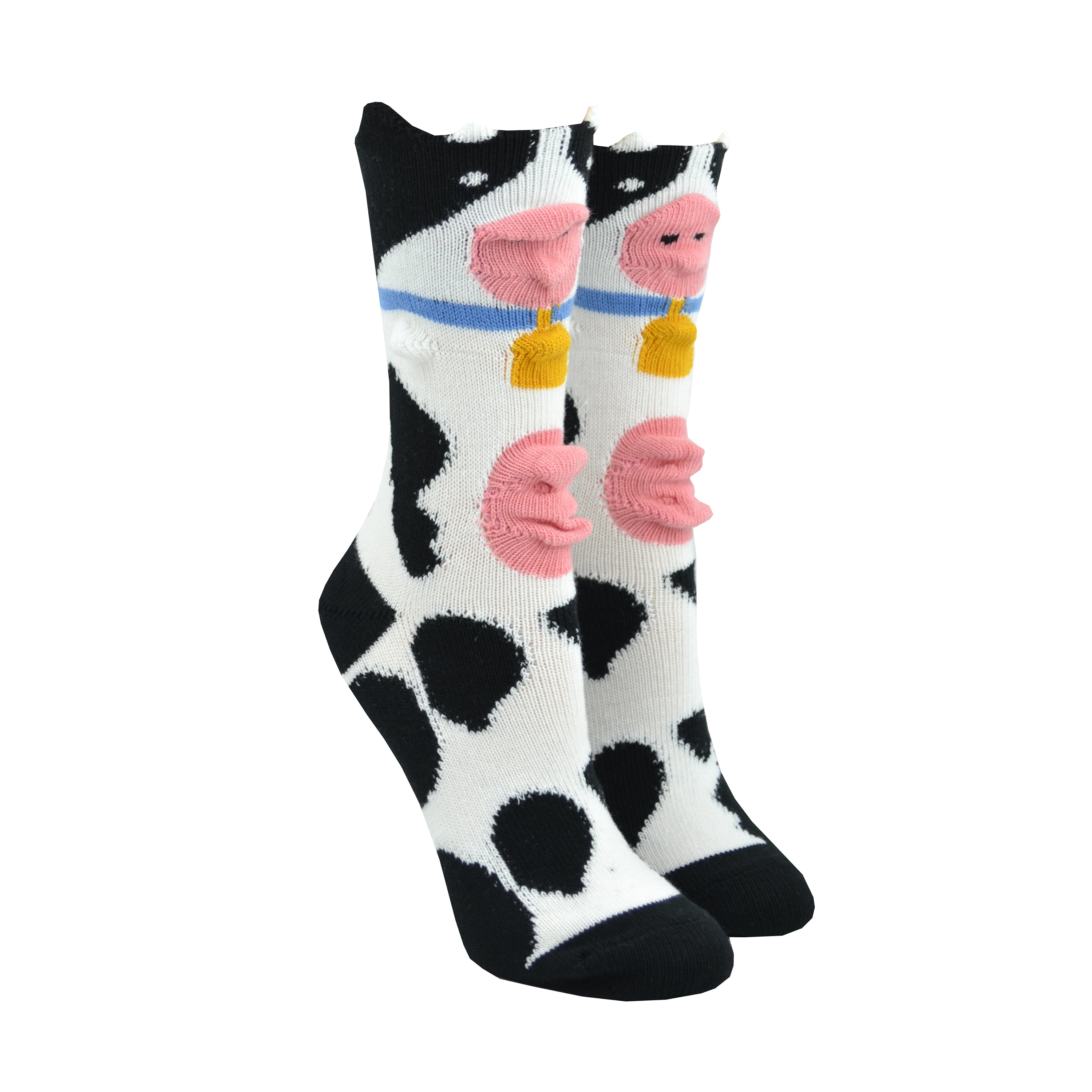 Shown on a foot mold, a pair of Foot Traffic, black and white women's cotton crew socks with three dimensional pattern of cute cow wearing a bell