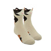 Shown on leg forms, a pair of Foot Traffic brand kids cotton crew sock in off white with light and dark brown spots like a calico cat! The top of the sock features a cute cat face and 2 ears.