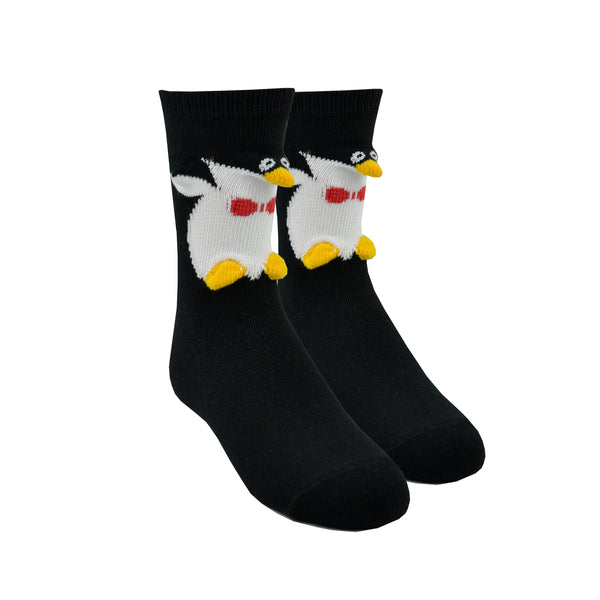 Shown on a leg form, these kids cotton crew length penguin socks by the brand Foot Traffic feature 3D flippers, nose, and feet.