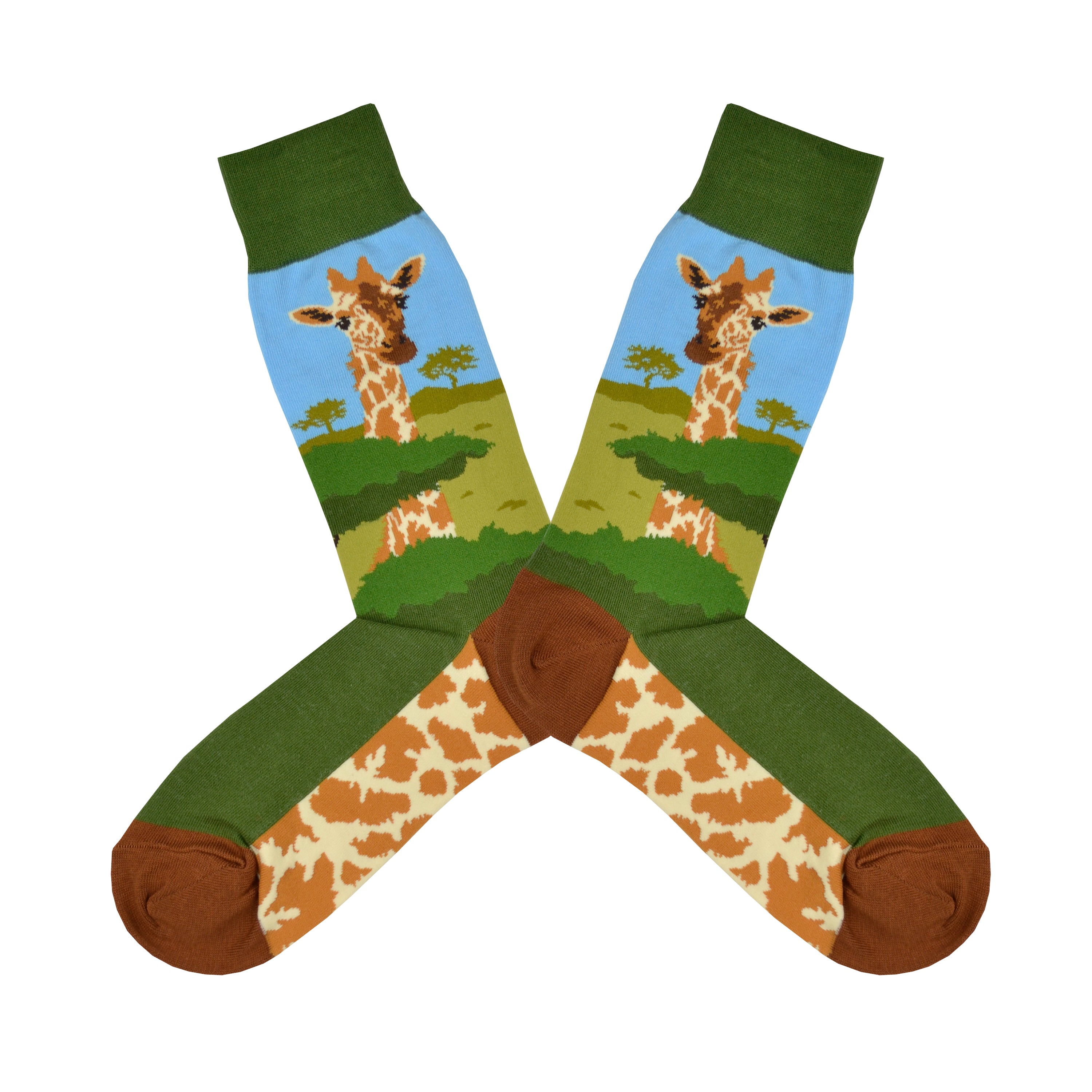 Shown in a flatlay, a pair of Foot Traffic green cotton men's crew socks with a giraffe and acacia trees