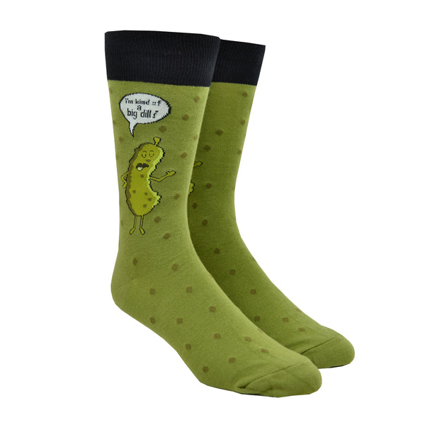 Shown on a leg form, these green cotton funny men's crew socks with a black cuff by the brand Foot Traffic have a picture of a talking dill pickle on them and a word bubble that says "I'm kind of a big dill".