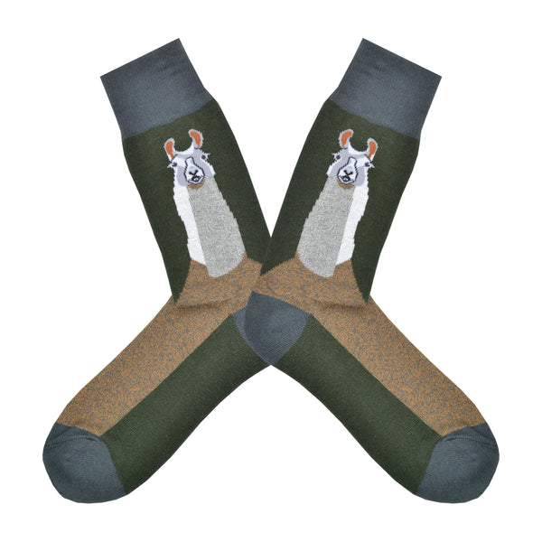 Shown in a flatlay, a pair of Foot Traffic green cotton men's crew socks with llama and brown foot