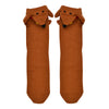 Shown in a flatlay, a pair of Foot Traffic, brown cotton women's crew socks with three dimensional pattern of cute brown dachshund dog