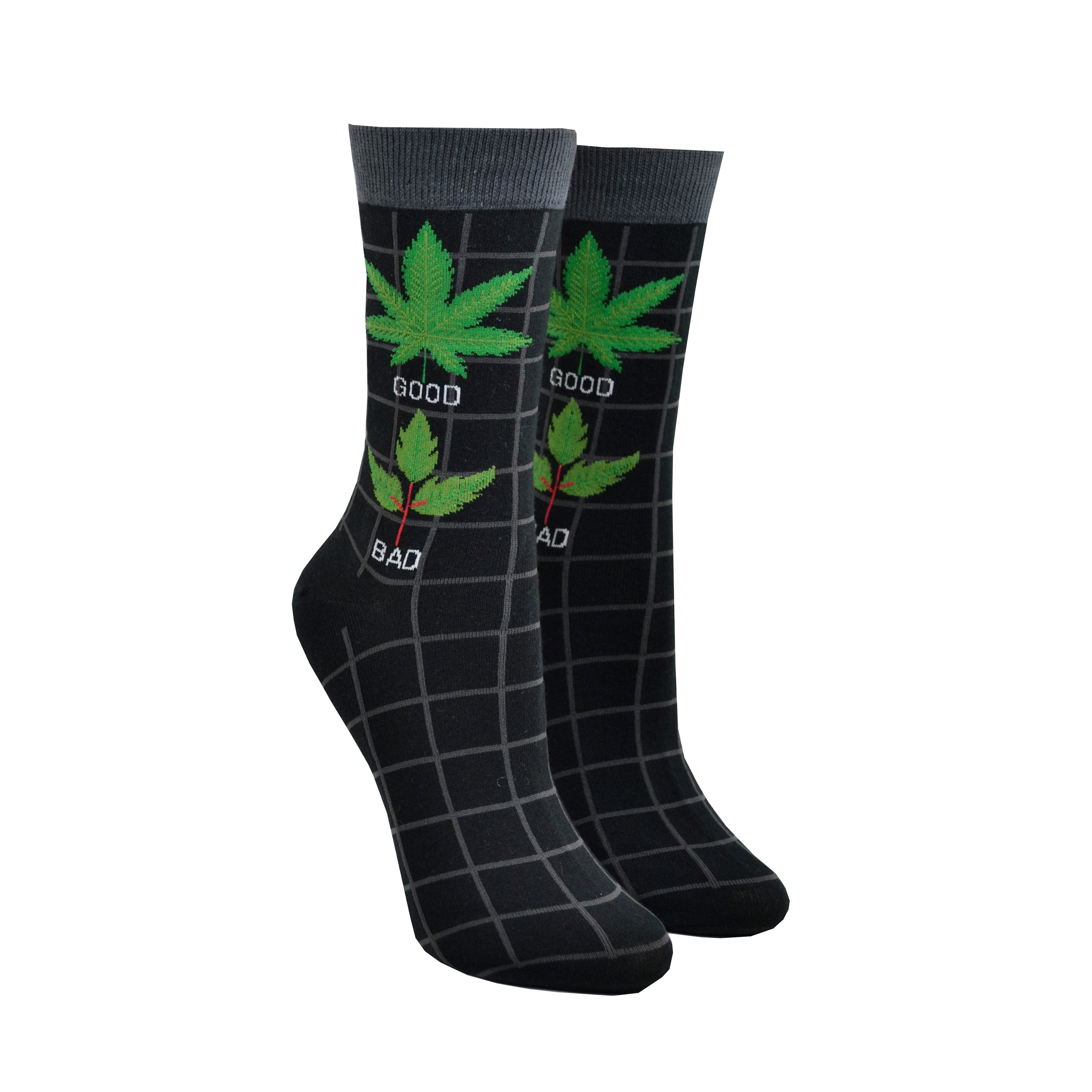 Shown on foot forms, a pair of women's Foot Traffic cotton crew socks in black with a grey cuff and a grey grid pattern. The leg of the sock has a marijuana leaf with the word 
