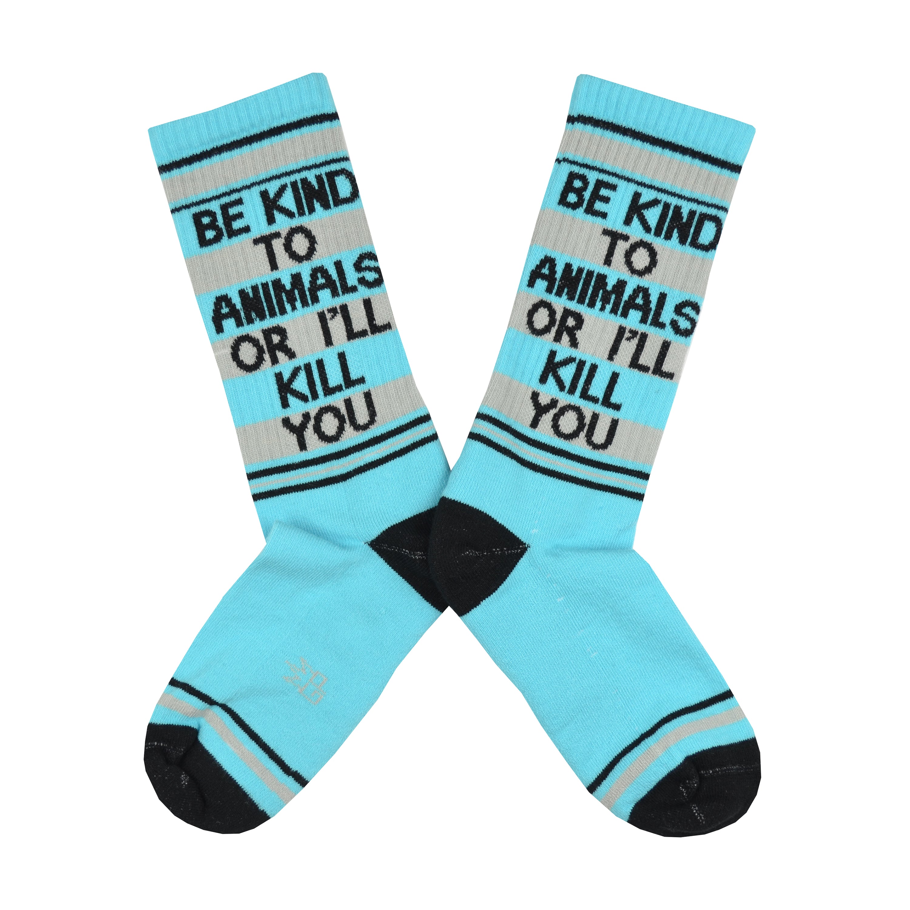 Shown in a flatlay, a pair of unisex cotton crew Gumball Poodle brand socks in light blue with black, blue, and grey stripes around the leg and cuff. The heel and toe are black and the leg of the sock reads in black font, BE KIND TO ANIMALS OR I'LL KILL YOU