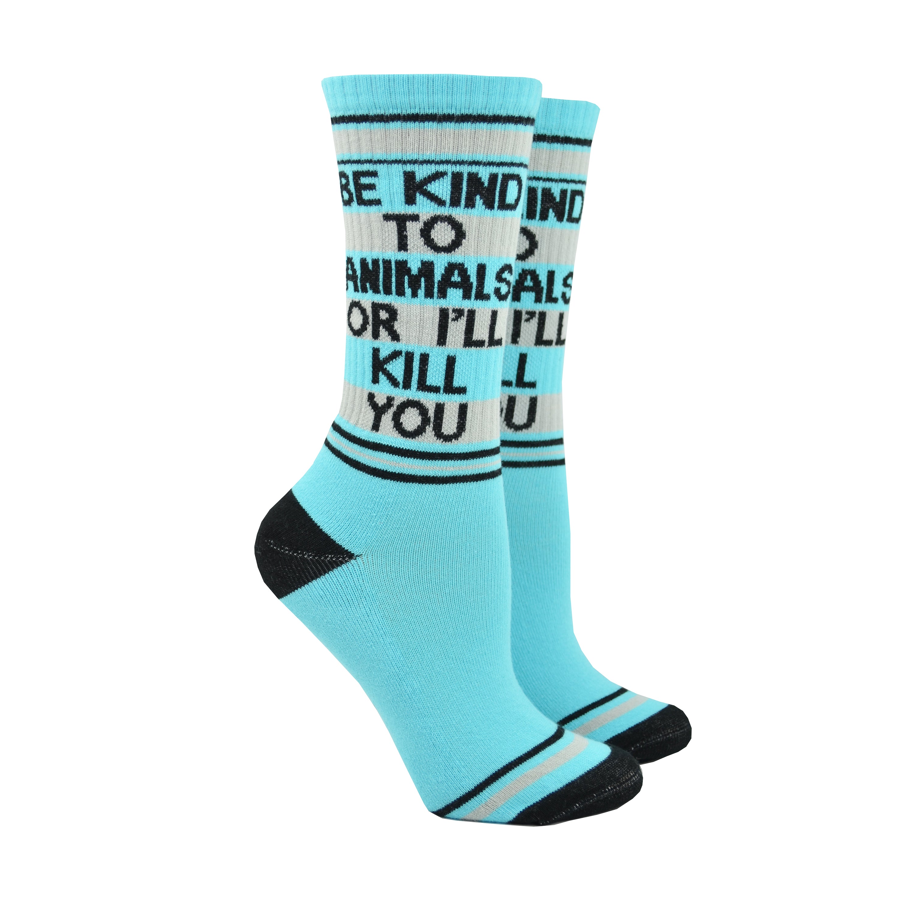 Shown on leg forms, a pair of unisex cotton crew Gumball Poodle brand socks in light blue with black, blue, and grey stripes around the leg and cuff. The heel and toe are black and the leg of the sock reads in black font, BE KIND TO ANIMALS OR I'LL KILL YOU