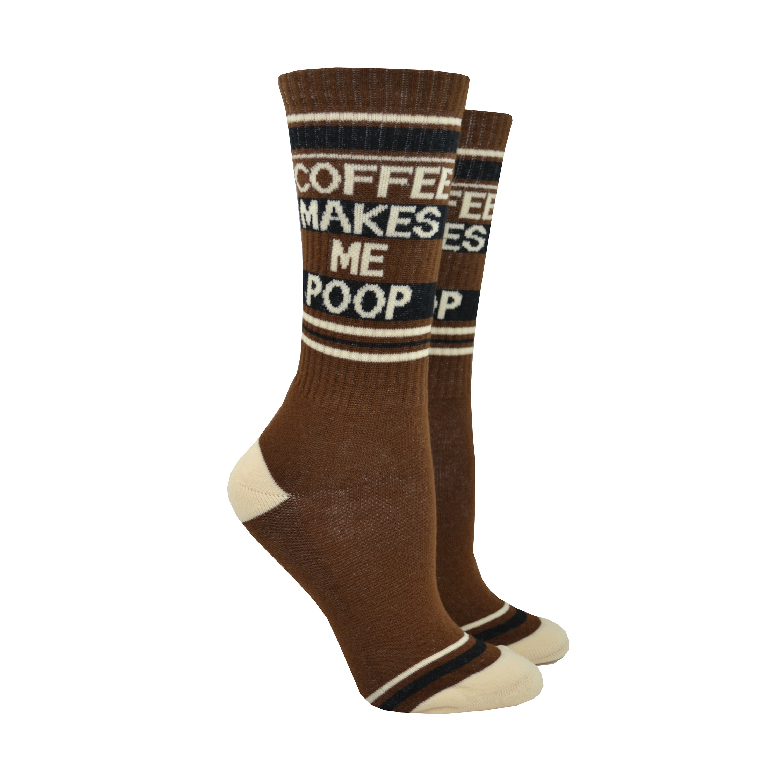 Shown on a foot mold, a pair of Gumball Poodle, dark brown cotton crew socks with tan heel/toe/accent stripes and “Coffee Makes Me Poop” text