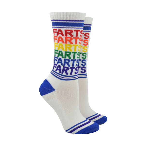 Shown on a foot mold, a pair of Gumball Poodle white cotton crew socks with blue toe/heel and rainbow repeating “Farts” text