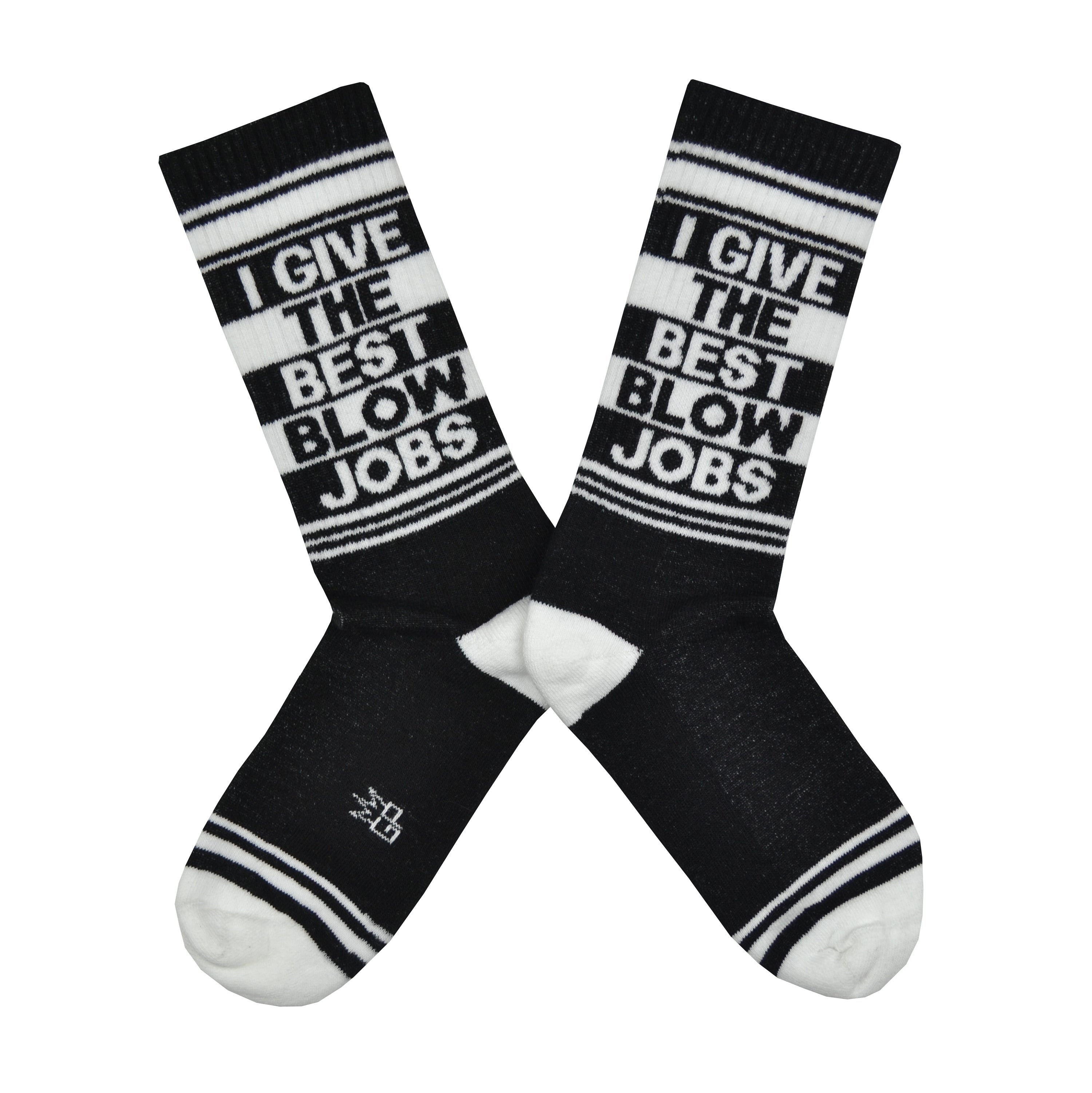 Shown in a flatlay, a pair of black cotton Gumball Poodle brand unisex crew socks with white striped cuff/heel/toe. These socks feature the phrase, 