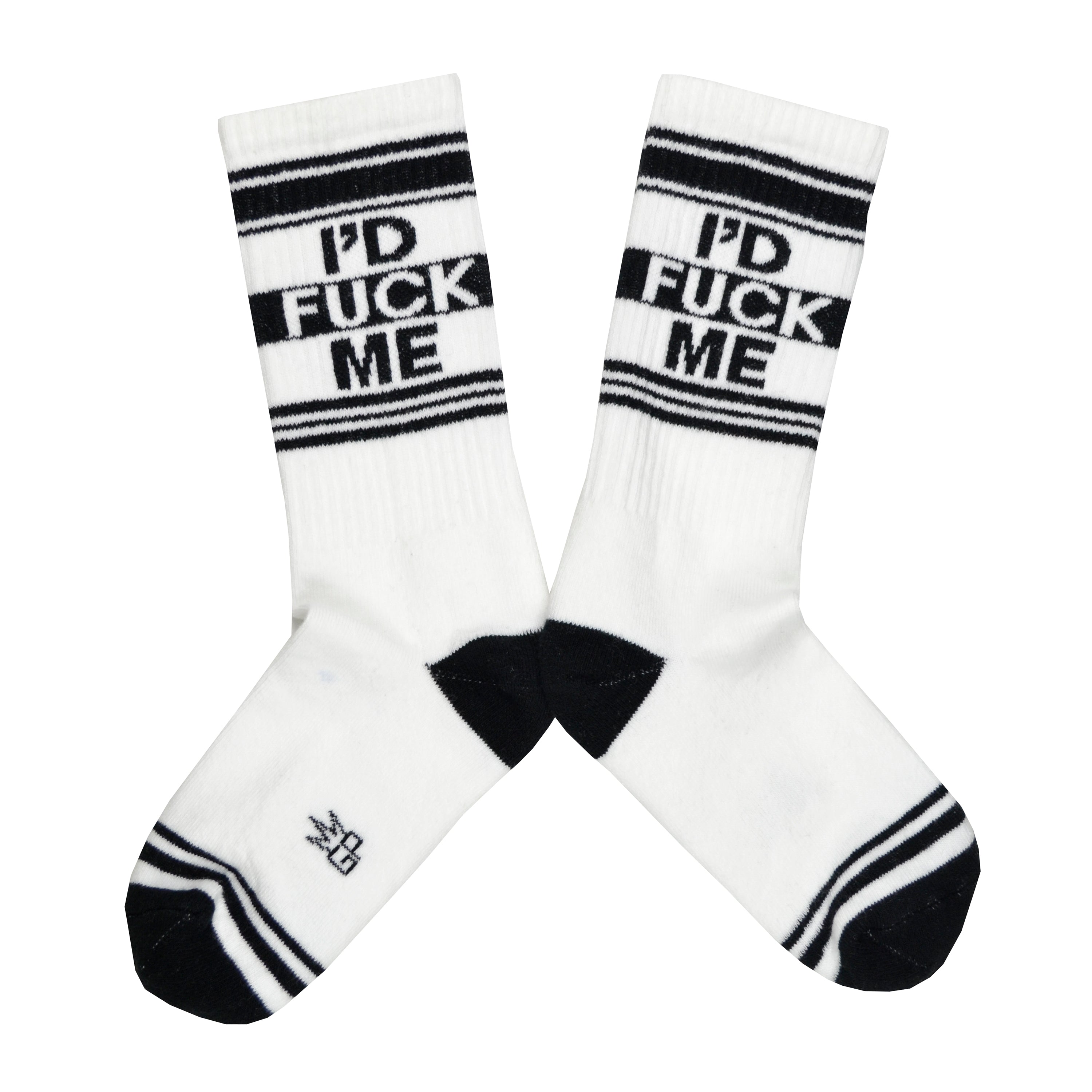 Shown in a flatlay, a pair of white cotton Gumball Poodle brand unisex crew socks with black and white striped heel/toe/cuff featuring the words, 