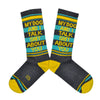 These gray cotton unisex crew socks with a yellow toe and yellow and blue striped cuff by the brand Gumball Poodle feature the words "MY DOG AND I TALK SHIT ABOUT YOU" on the leg.