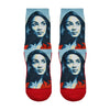 Shown in a flatlay, a pair of Good Luck Socks’ polyester-cotton women’s crew socks with portrait of Alexandria Ocasio-Cortez in shades of red, white and blue