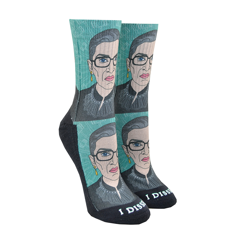 Shown in size small on leg forms, a pair of Good Luck Socks brand unisex green polyester and cotton crews socks. The front of these socks features a caricature of the iconic Supreme Court Justice Ruth Bader Ginsburg in one of her well-known collars with the words 