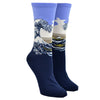 Shown on a leg form, these purple cotton women's crew socks by the brand Hot Sox feature the famous print The Great Wave by the Japanese artist Hokusai.